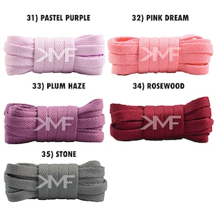 May include: Five different colors of shoelaces, each rolled up and tied in a knot. The colors are pastel purple, pink, plum, rosewood, and stone.