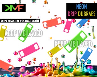 May include: Neon colored plastic shoe lace dubrae clips. The dubraes are in various colors including pink, green, yellow, and blue. The text "KEEP ME LACED" is written in black letters on a white background. The text "NEON DRIP DUBRAES" is written in white letters on a black background.