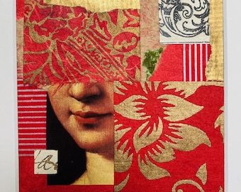 May include: Mixed media collage art piece in a white frame. The artwork features a woman's lips and various textured paper elements in red, gold, and cream. Floral and patterned designs are visible, creating a layered and artistic composition.