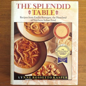 May include: The Splendid Table cookbook with a white background and a photo of three bowls of pasta. The book has won both the James Beard Foundation Cookbook of the Year and the Julia Child Cookbook Award.