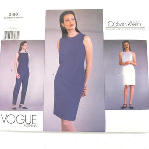 May include: Vogue Patterns sewing pattern featuring Calvin Klein designs. The pattern includes images of a sleeveless dress, jumpsuit, and a white dress. The pattern number is 2166.