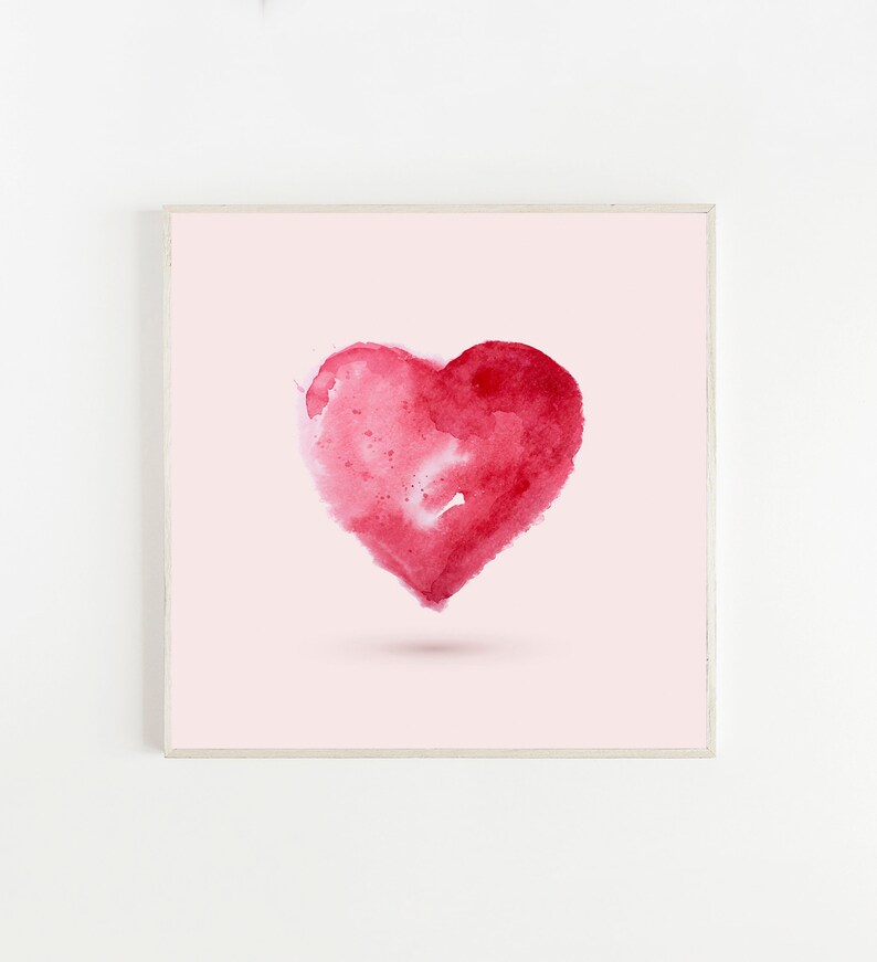 May include: A framed watercolor painting of a red heart on a light pink background.