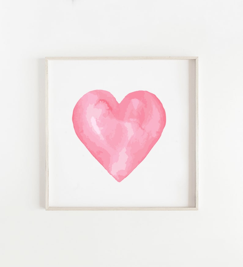 May include: A framed watercolor painting of a pink heart on a white background.