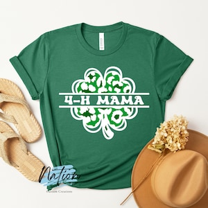 May include: Green t-shirt with a white four-leaf clover design and the text "4-H MAMA" inside the clover.