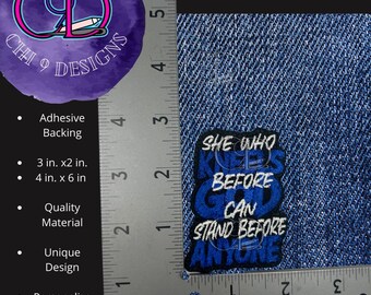 May include: Embroidered patch on a blue denim background. The patch is blue with white text that reads "She who kneels before God can stand before anyone". The patch is 2 inches by 2 inches.