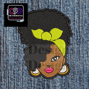 May include: Embroidered patch featuring a cartoon illustration of a Black woman with an afro hairstyle, wearing a yellow headband and gold hoop earrings. The background is a denim fabric.