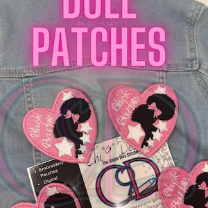 May include: Three pink heart-shaped iron-on patches with white stars and a black silhouette of a girl with a bow in her hair. The text "Black Barbie" is written on each patch.