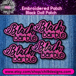 May include: Four pink and black embroidered patches with the text "Black Barbie" on a denim background.