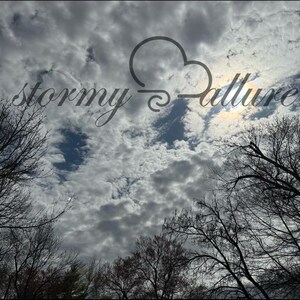 May include: A cloudy sky with the text "stormy allure" superimposed on it. The sun is shining through the clouds.