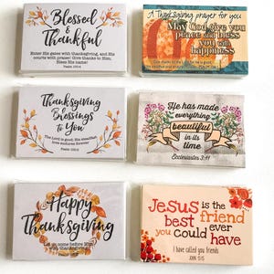 May include: A collection of six rectangular Thanksgiving-themed magnets. Each magnet features a different design with fall colors, floral accents, and inspirational quotes. The magnets include phrases like "Blessed & Thankful" and "Happy Thanksgiving."