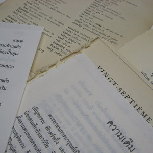 May include: A close-up of a page from a French language textbook. The page is titled "VINGT-SEPTIÈME LEÇON" and features the word "ความเดิม" in Thai script.