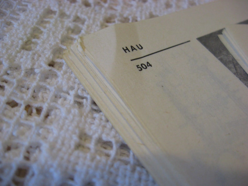 May include: Close-up of a book page with the text "HAU 504" printed on it.