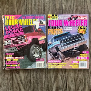May include: Two vintage Four Wheeler magazines featuring off-road vehicles on the covers. The left magazine shows a red truck with the text Legal Power, while the right magazine displays a silver truck with the text Severe-Duty Parts and 10 Best Buys.