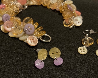 Repurposed Button Bracelet set in shades of cream, pink, lavender and peach - with shell buttons. Comes with two pair of matching earrings.