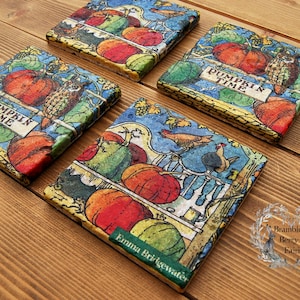 May include: Set of four colourful square coasters featuring a vintage illustration of pumpkins, owls, and other autumn harvest imagery. The coasters feature the text "Pumpkin Time" and the name "Emma Bridgewater".