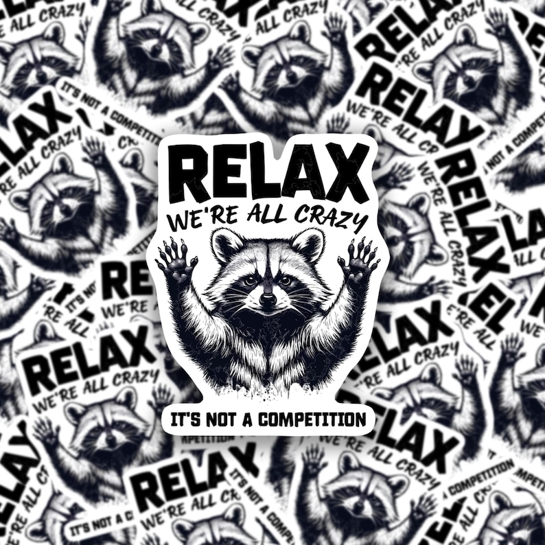 May include: A black and white sticker with a raccoon illustration and the text "Relax We're All Crazy It's Not A Competition".