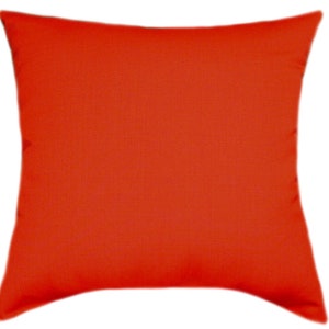 May include: A solid orange throw pillow with a square shape and a slightly textured fabric.