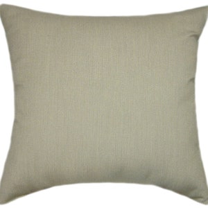 May include: A plain, light beige throw pillow with a subtle textured fabric.