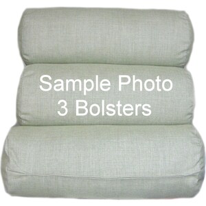 May include: Three light green cylindrical bolsters stacked on top of each other. The middle bolster has the text "Sample Photo 3 Bolsters" printed on it.