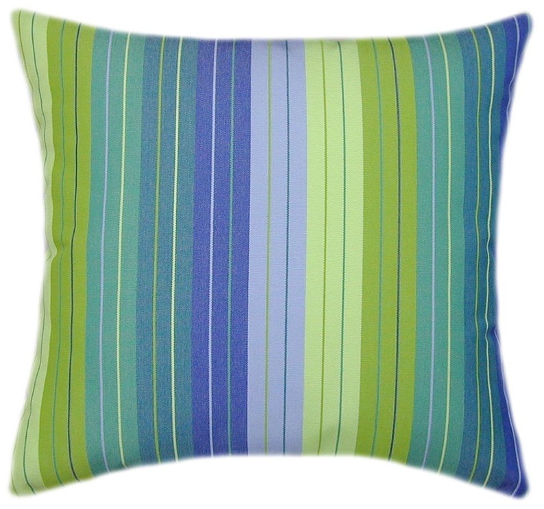 May include: A striped pillow with green, blue, and light blue stripes. The pillow is rectangular and has a soft, plush feel.
