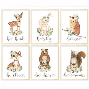 May include: Set of six watercolor prints featuring woodland animals with floral crowns and inspirational messages. The animals include a deer, rabbit, owl, fox, bear, and squirrel. Each print has a different message, such as "be kind", "be silly", "be wise", "be clever", "be brave", and "be curious".