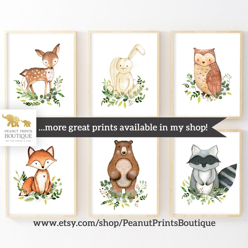 May include: Set of six watercolor animal prints featuring a deer, rabbit, owl, fox, bear, and raccoon. Each animal is surrounded by green foliage. The prints are perfect for a nursery or child's room.