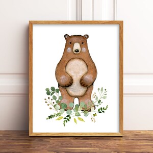 May include: A watercolour illustration of a brown bear standing on a white background with green leaves and yellow flowers around it.