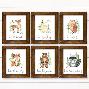 May include: Six framed prints with watercolor illustrations of woodland animals and inspirational messages. The prints feature a deer, rabbit, owl, fox, bear, and raccoon. The messages are "be kind", "be silly", "be wise", "be clever", "be brave", and "be curious".
