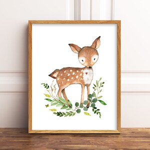 May include: A watercolour painting of a brown fawn with white spots standing in a bed of green leaves. The fawn has a small red heart on its chest.