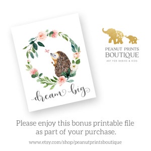 May include: A watercolor illustration of a hedgehog with a pink butterfly in a floral wreath with the text "dream big".