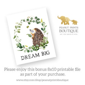 May include: A watercolor illustration of a hedgehog in a green leafy wreath with a butterfly. The text "DREAM BIG" is below the wreath.