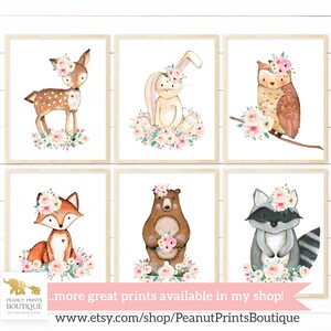 May include: Set of six watercolor illustrations featuring woodland animals with floral crowns. The animals include a deer, rabbit, owl, fox, bear, and raccoon. Each animal is surrounded by pink and white flowers.