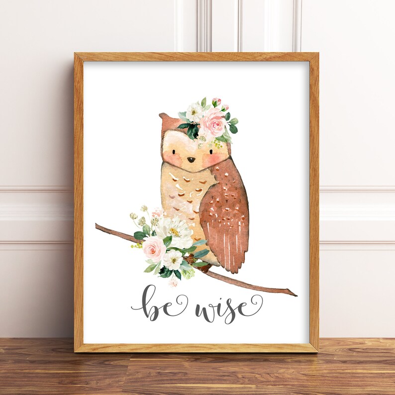 May include: A watercolor illustration of an owl wearing a pink flower crown, perched on a branch with white and pink flowers. The text "be wise" is written below the owl.