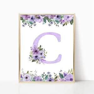 May include: A printable wall art design featuring the letter C in a light purple color with a watercolor effect. The letter is surrounded by a floral border of purple and white flowers with green leaves.