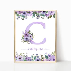 May include: A printable art print featuring a watercolor illustration of a purple letter C with a floral design. The name "catarina" is written below the letter in a cursive font.