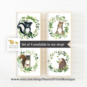 May include: Set of four watercolor illustrations featuring woodland animals, including a skunk, rabbit, squirrel, and hedgehog. Each animal is surrounded by a green leafy wreath.