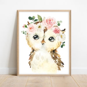 May include: A watercolor painting of a brown and white owl with large eyes wearing a pink and white flower crown. The owl is looking directly at the viewer.