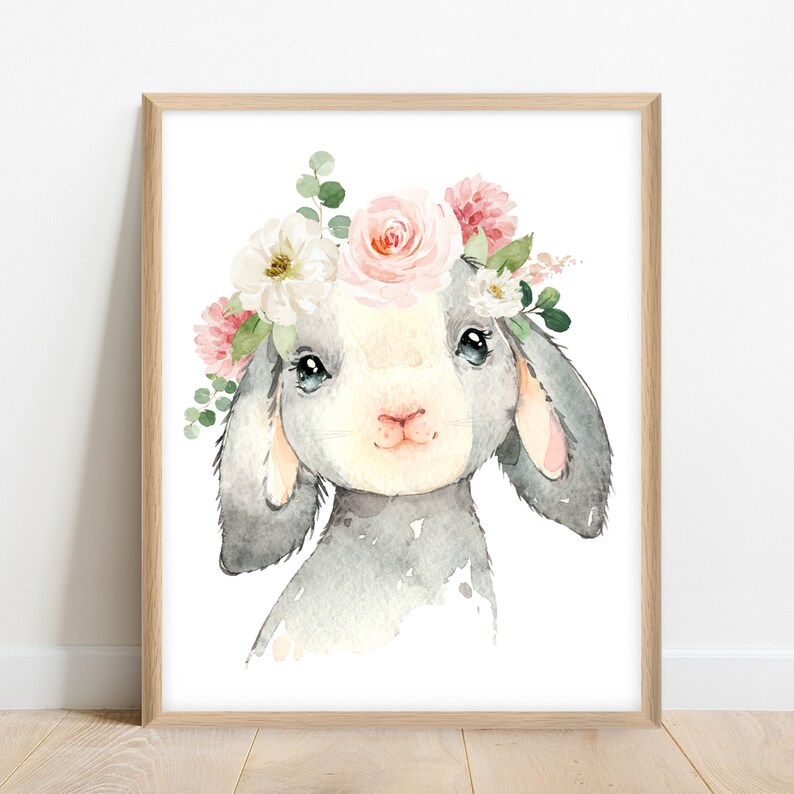 May include: A watercolor painting of a gray bunny wearing a pink and white flower crown. The bunny has a white face and pink ears. The flowers are painted in a realistic style.