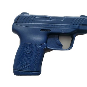 Puede incluir: Una pistola azul marino con el texto "380 AUTO" en la parte superior. El arma tiene un agarre texturizado y el logotipo de Ruger. La imagen est&aacute; sobre un fondo blanco.