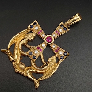 Large Cross of the Angels in 18 kt gold, Rubies, Brilliants and Sapphires