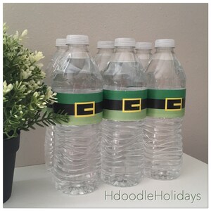 May include: A set of six clear plastic water bottles with green, black, and yellow labels that say "Hdoodle Holidays".