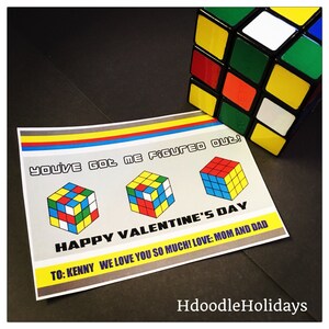 May include: A Valentine's Day card with a Rubik's Cube theme. The card features three Rubik's Cubes and the text "You've got me figured out! Happy Valentine's Day. To: Kenny We love you so much! Love: Mom and Dad."