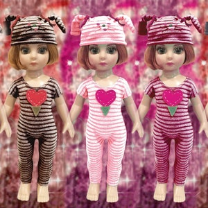 May include: Five dolls wearing striped pajamas with a heart-shaped patch and matching cat-eared hats in various colors, including pink, brown, gray, and orange.