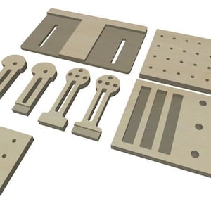 May include: A set of seven beige wooden pieces for building a miniature dollhouse. The pieces include a flat roof, two walls with windows, a wall with a door, and three small pieces with holes.