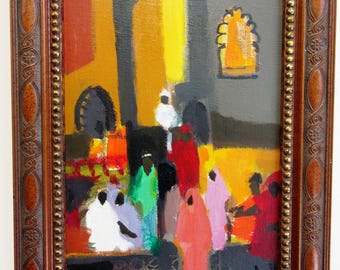 May include: An abstract painting in a decorative brown wooden frame. The artwork depicts figures in colorful robes, with shades of red, green, and pink, set against a backdrop of yellow and gray. The painting evokes a marketplace scene.