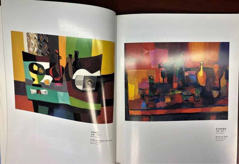 May include: Two abstract still life paintings with a cubist style. The first painting features a table with a green tablecloth, a bowl of fruit, a bottle of wine, and a guitar. The second painting features a table with a red tablecloth, a bottle of wine, and a glass of wine.