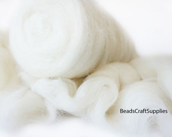 May include: A close-up of a pile of white wool roving. The wool is soft and fluffy, and it is perfect for felting, spinning, or other craft projects.