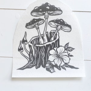 May include: Black and white illustration of three mushrooms growing out of a tree stump with a single white flower.