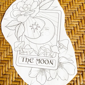 May include: A black and white illustration of the The Moon tarot card. The card features a crescent moon with a face, a five-pointed star, and mushrooms.