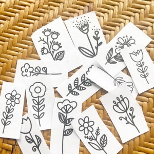 May include: A set of ten black and white printable flower illustrations. Each illustration features a different flower design with simple lines and shapes.